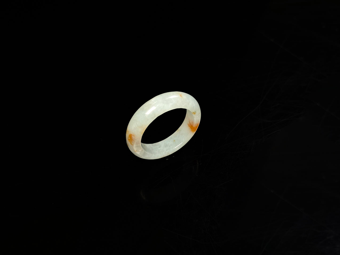 A icy white with amber hue jadeite ring.