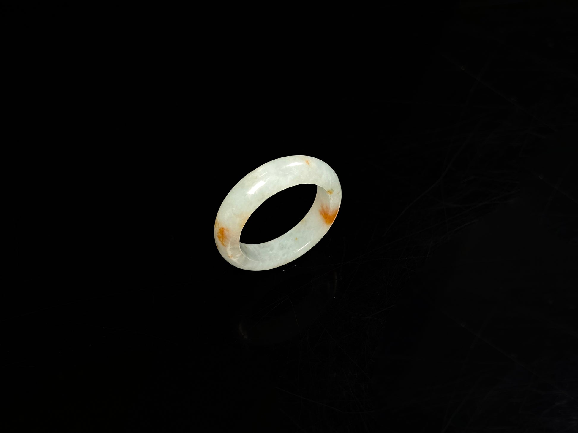 A icy white with amber hue jadeite ring.