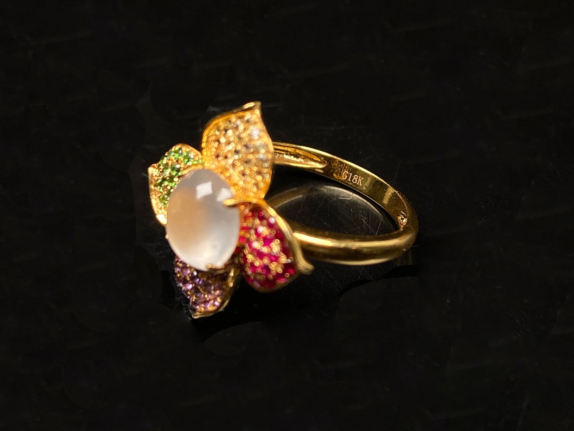 A icy white with vibrant petal jadeite ring.