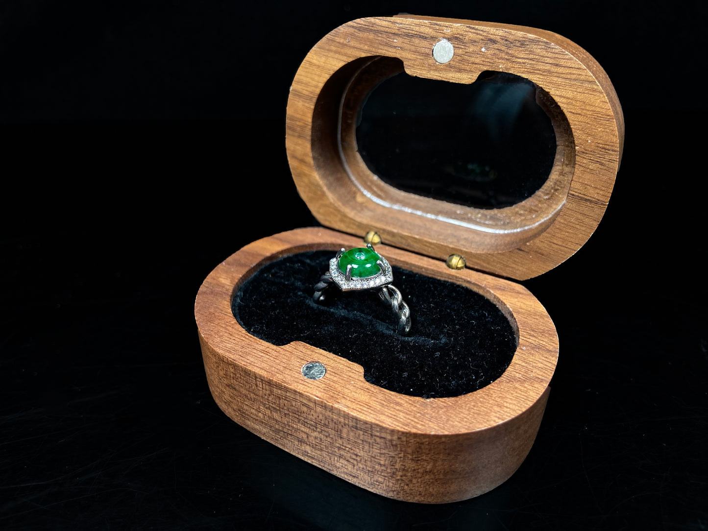 A curb chain green jadeite ring.