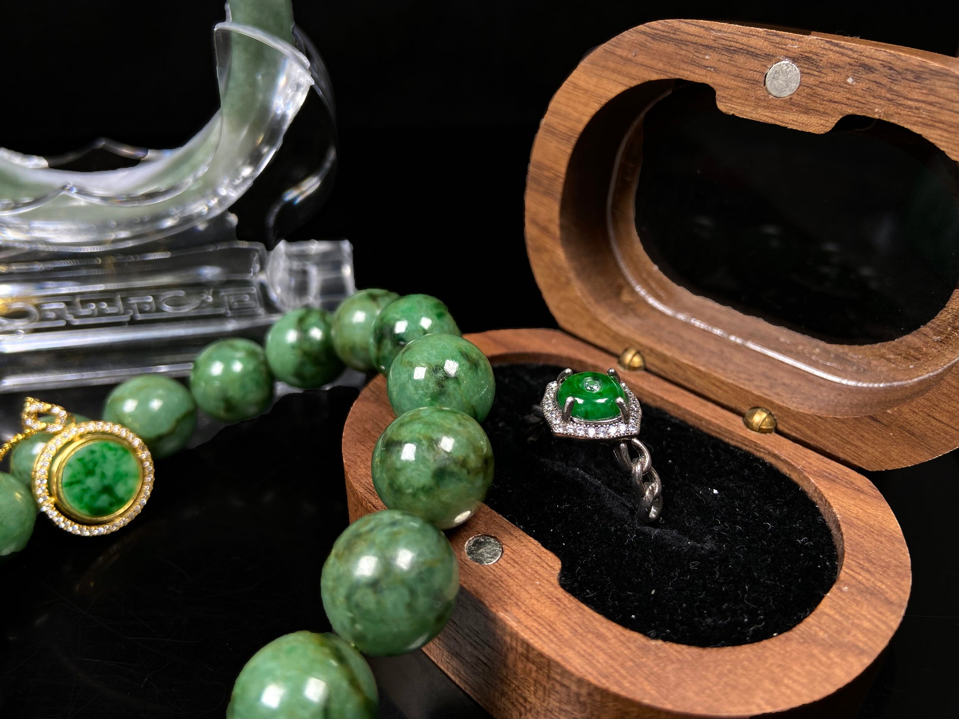 A curb chain green jadeite ring.