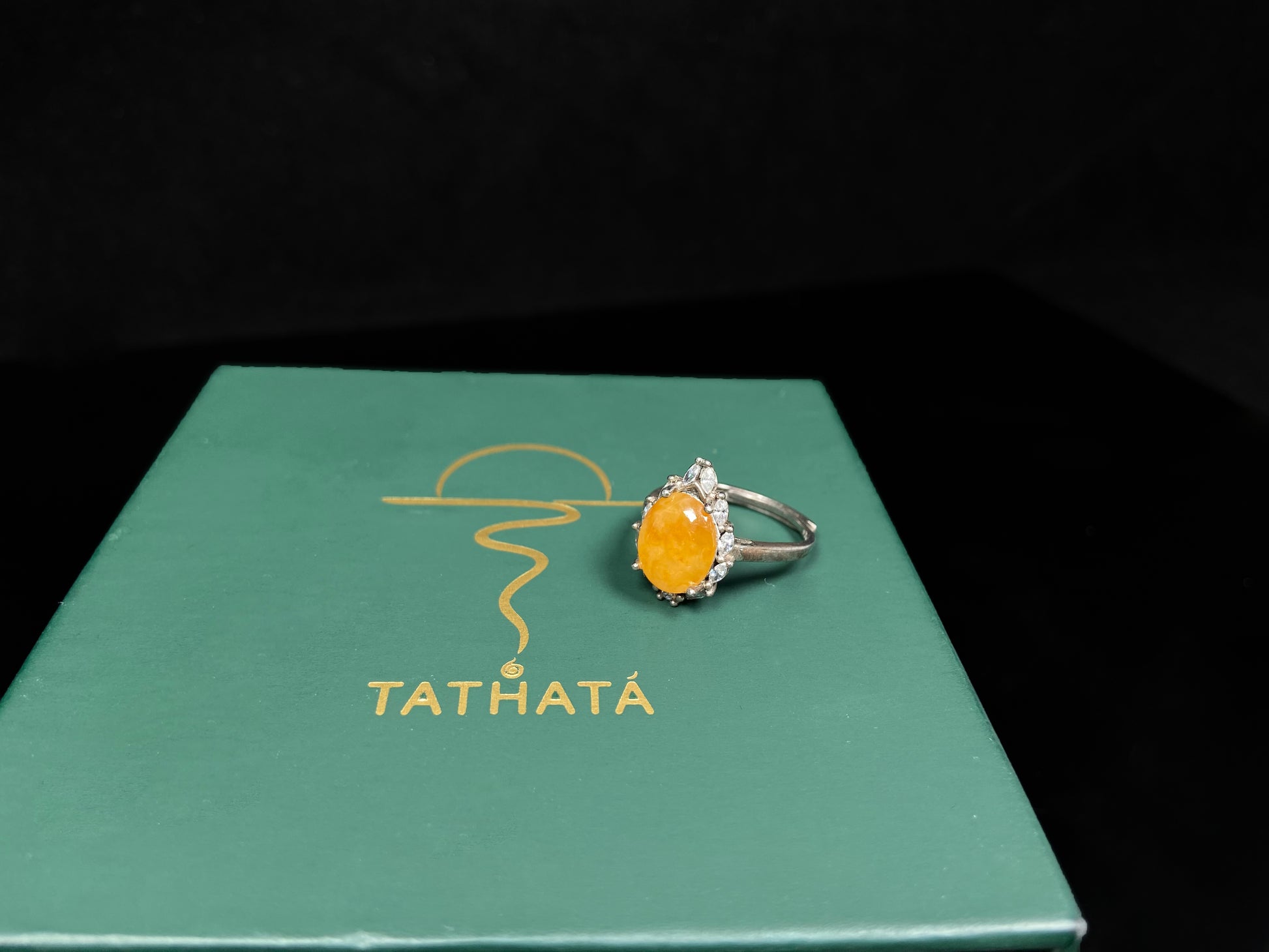 A chrysanthemum sunlit glow jadeite ring.