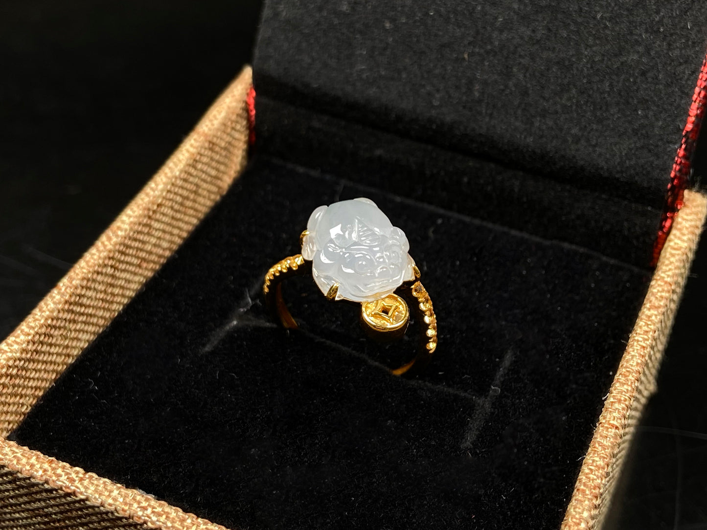 A icy white fortune Pixiu jadeite ring.