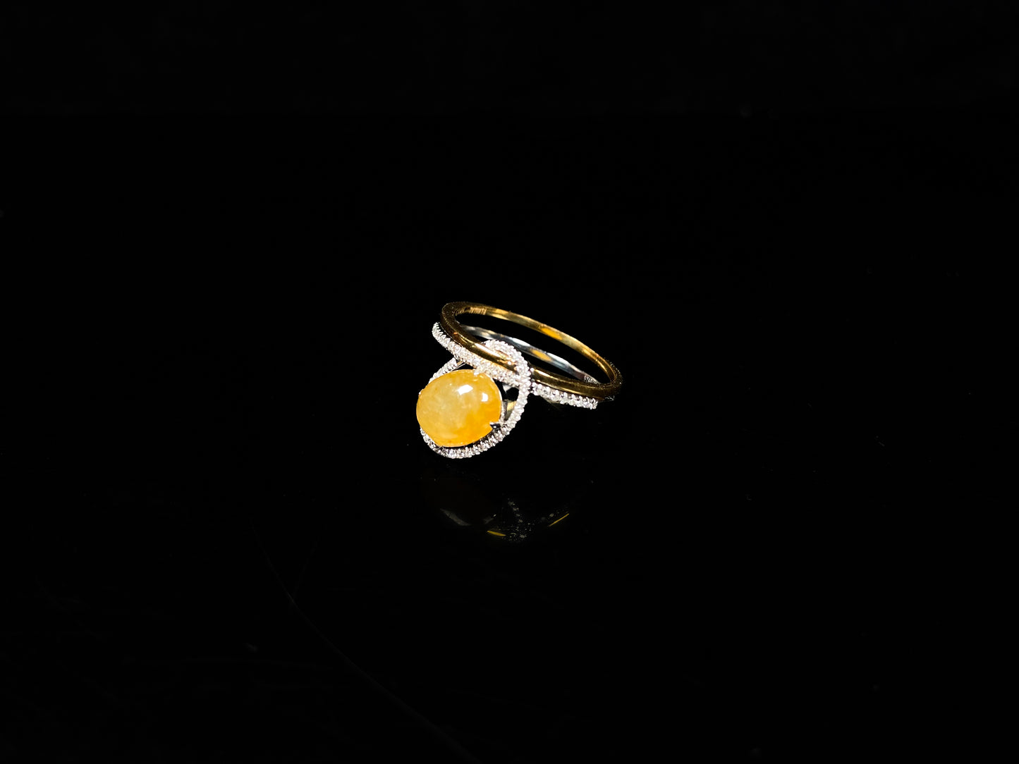 A yellow interlock star halo jadeite ring.