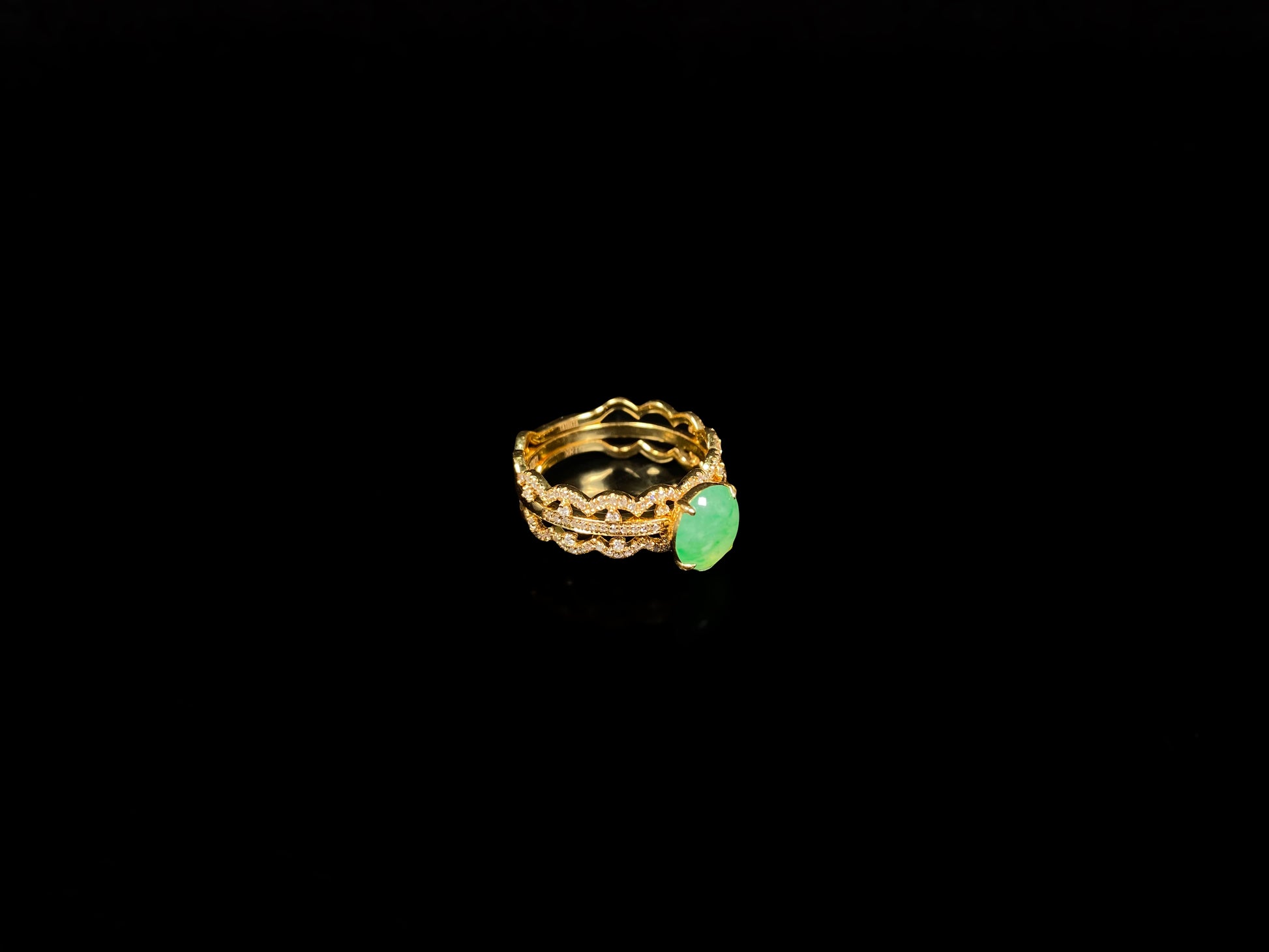 A golden wave apple hue jadeite ring.