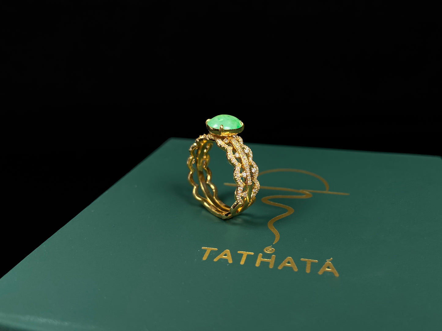A golden wave apple hue jadeite ring.