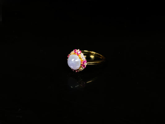 A round lavender pink accent jadeite ring.