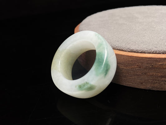 A floating yellow and green thumb ring jadeite ring.