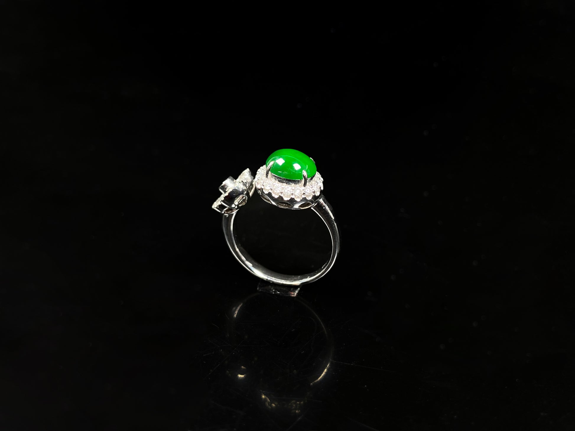 A vivid imperial green halo jadeite ring.