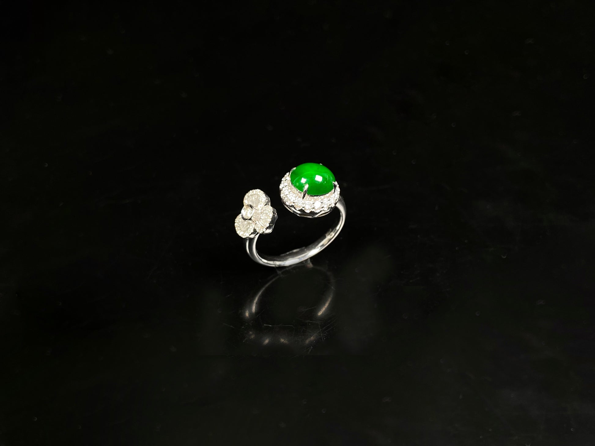 A vivid imperial green halo jadeite ring.