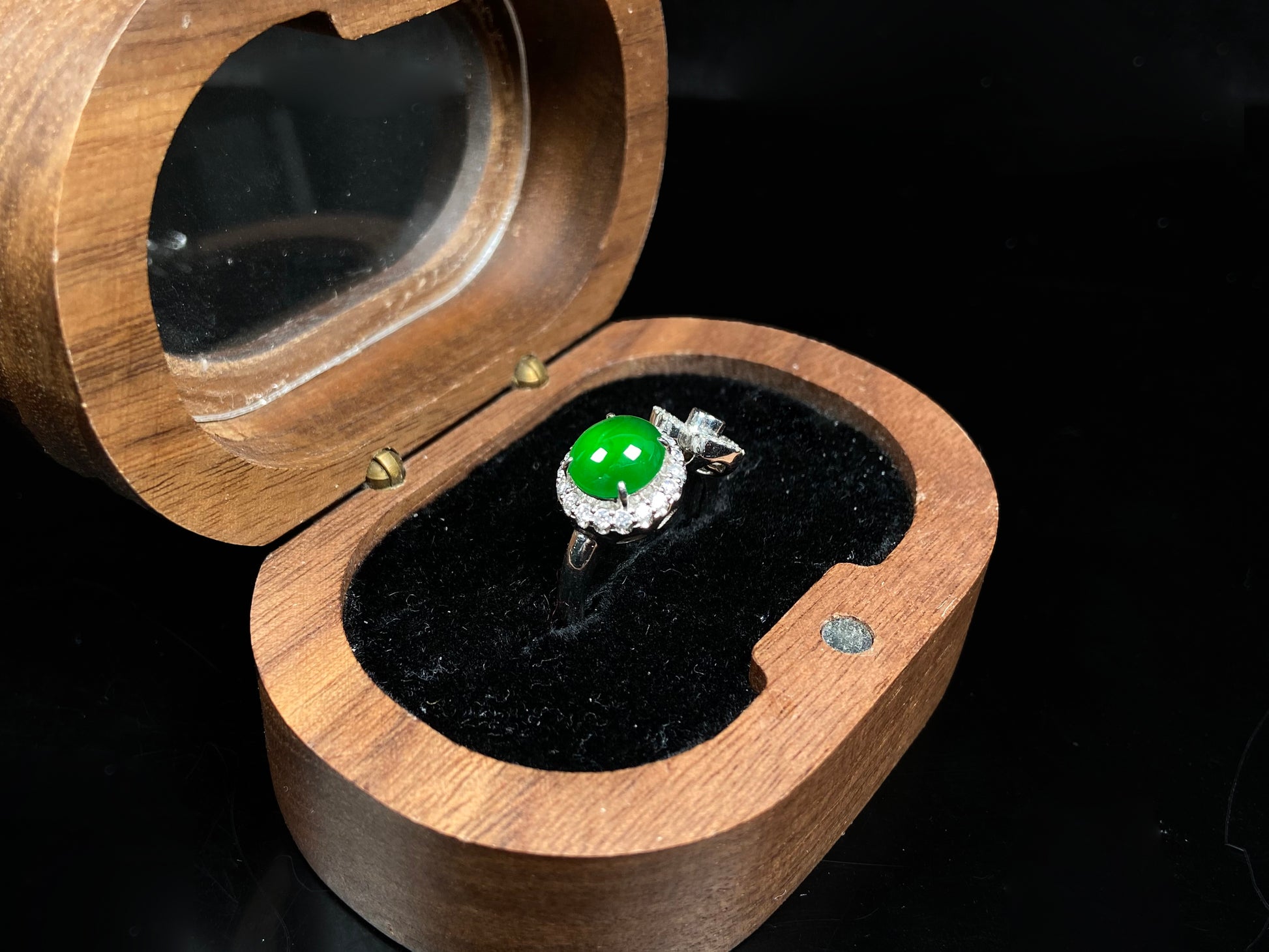 A vivid imperial green halo jadeite ring.