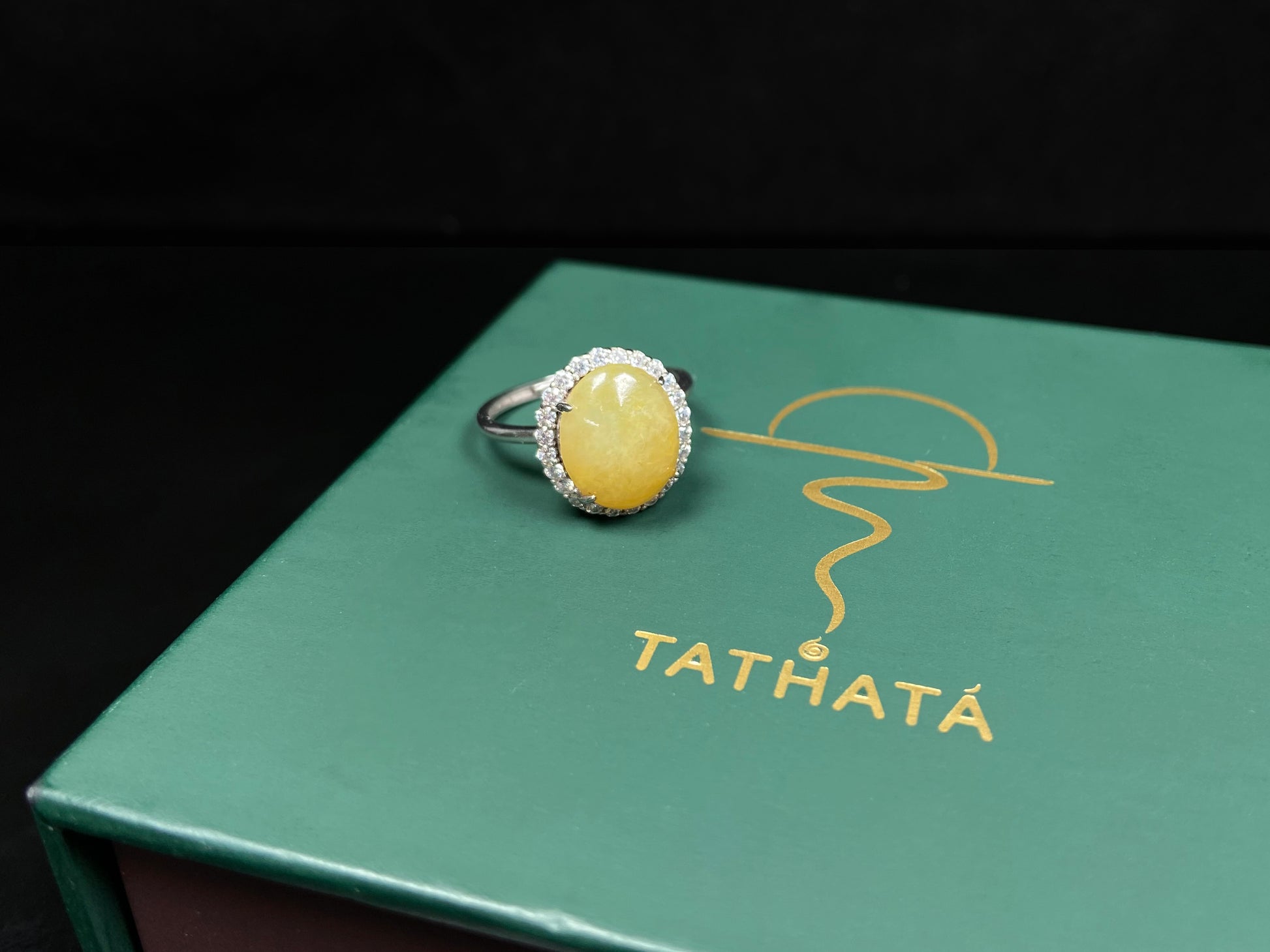 A warm honeyed glimmer jadeite ring.