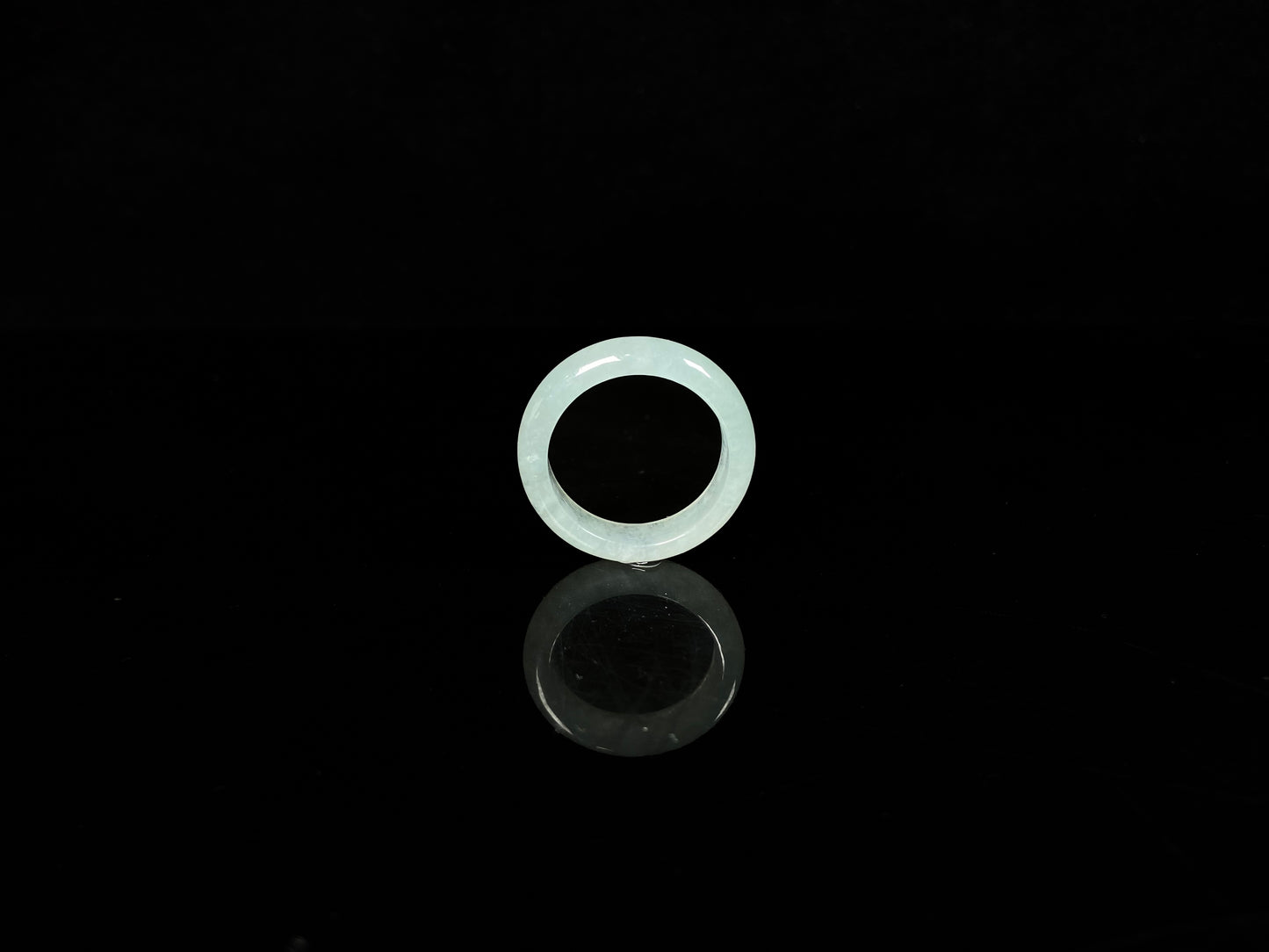 A transparent icy white jadeite ring.