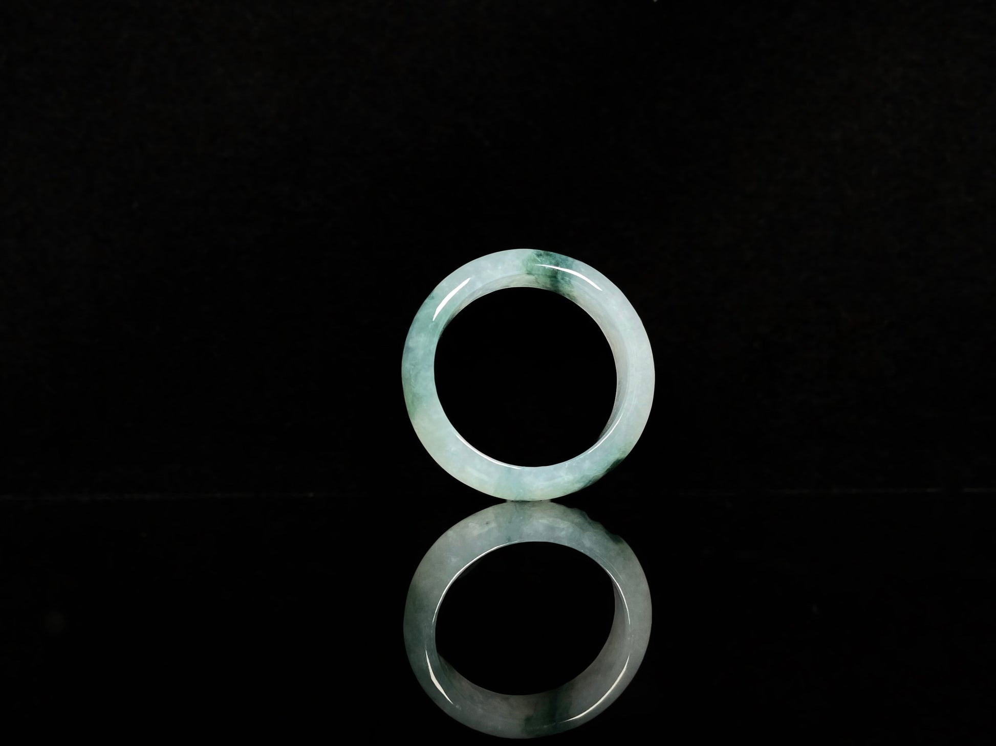 A pale white floating green jadeite ring.