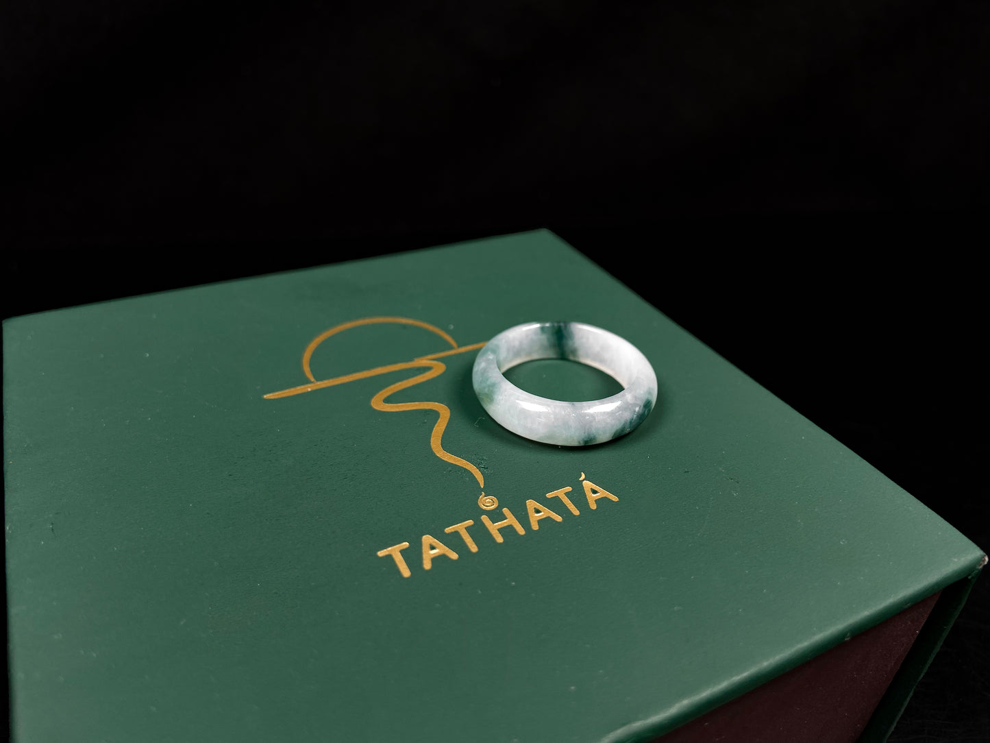 A pale white floating green jadeite ring.