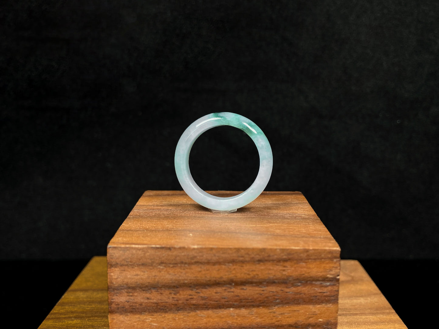 A milky white with green veins jadeite ring.