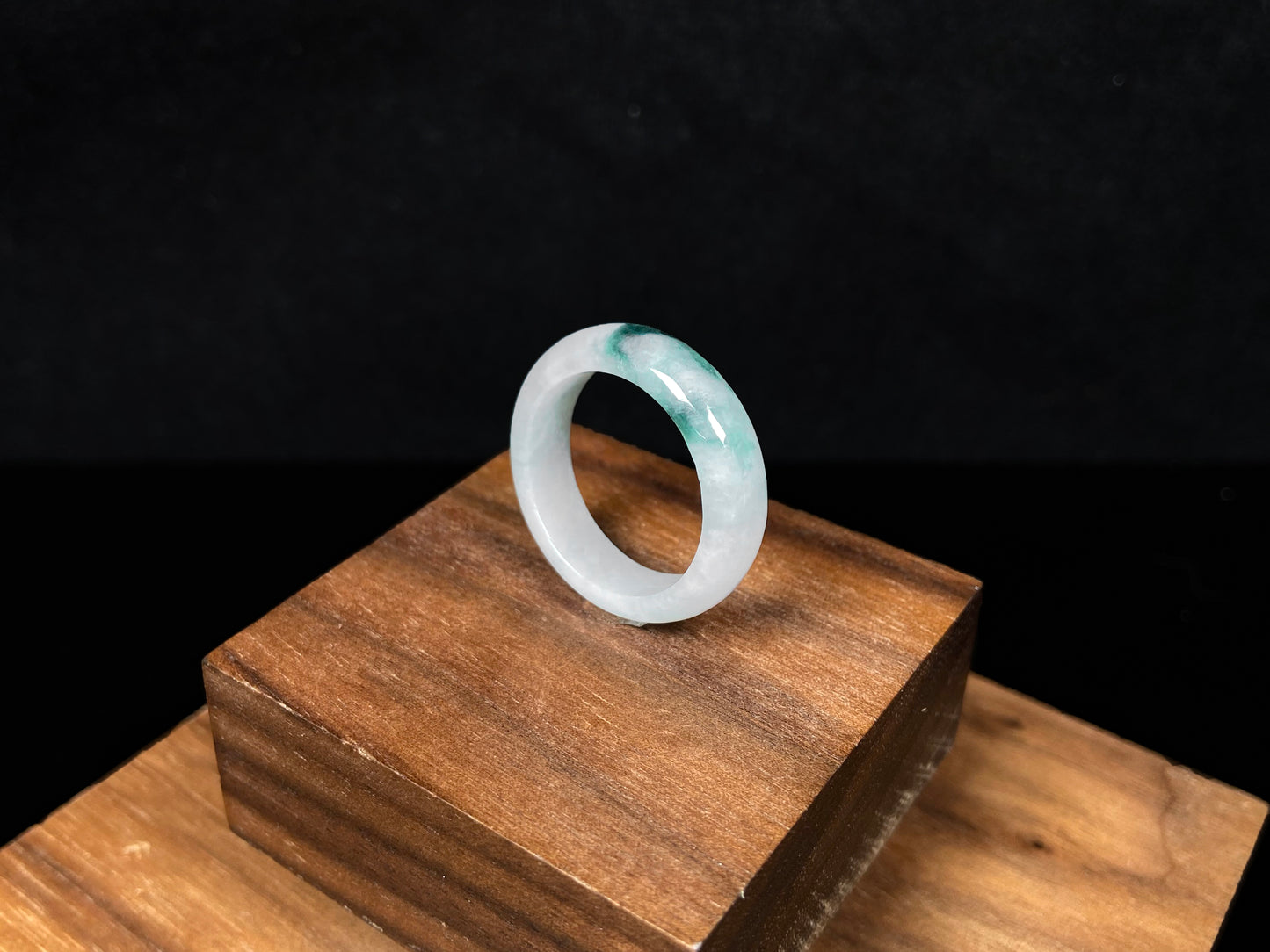 A milky white with green veins jadeite ring.
