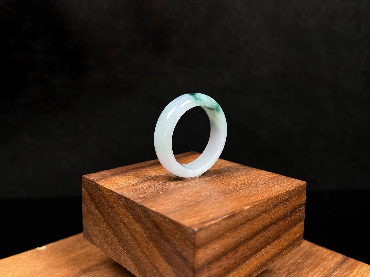 A milky white with green veins jadeite ring.