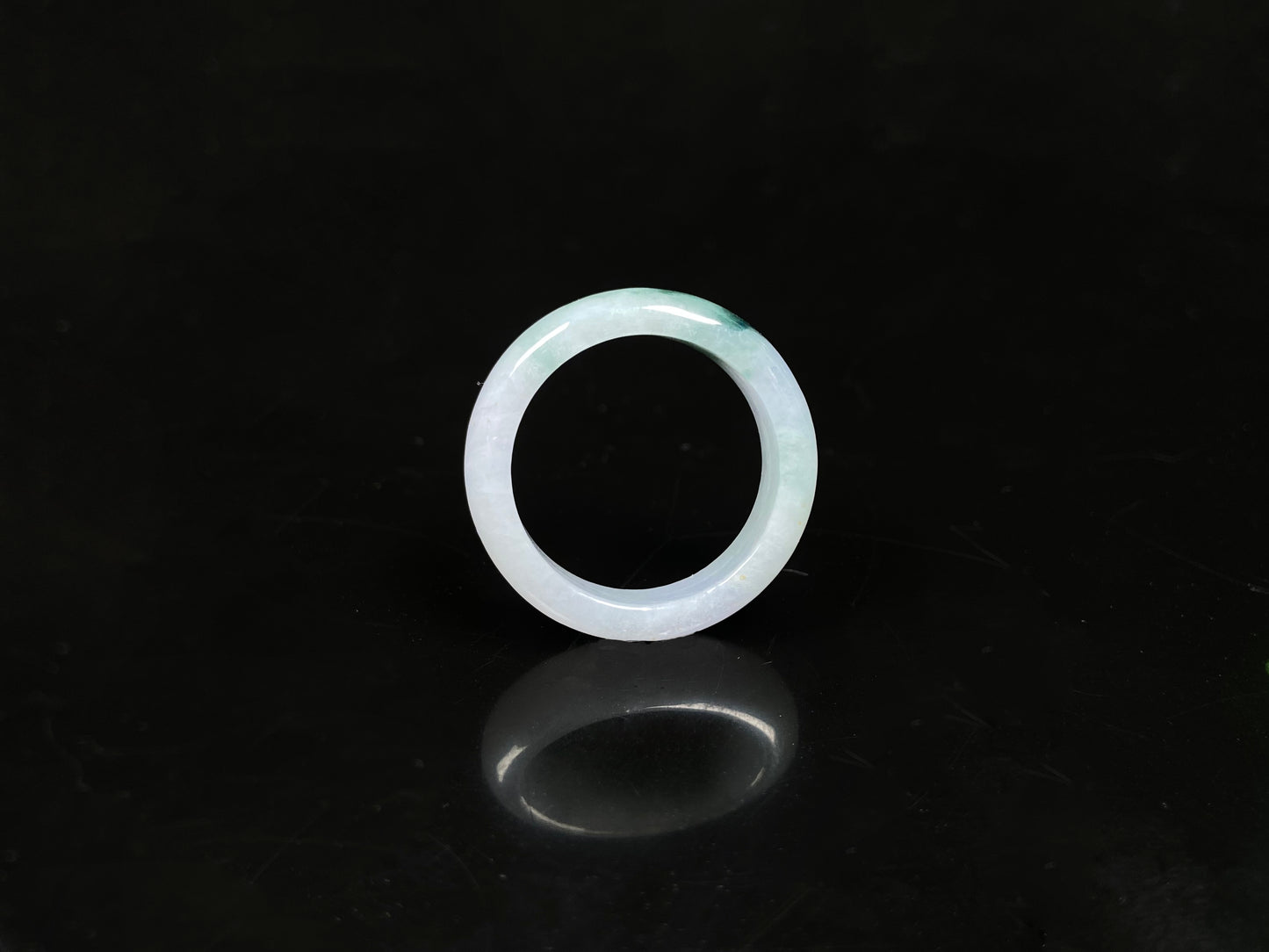 A milky white with green veins jadeite ring.