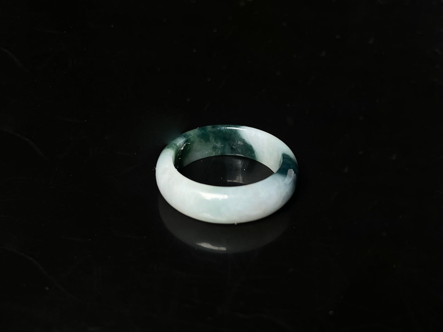 A ink green cloud jadeite ring.