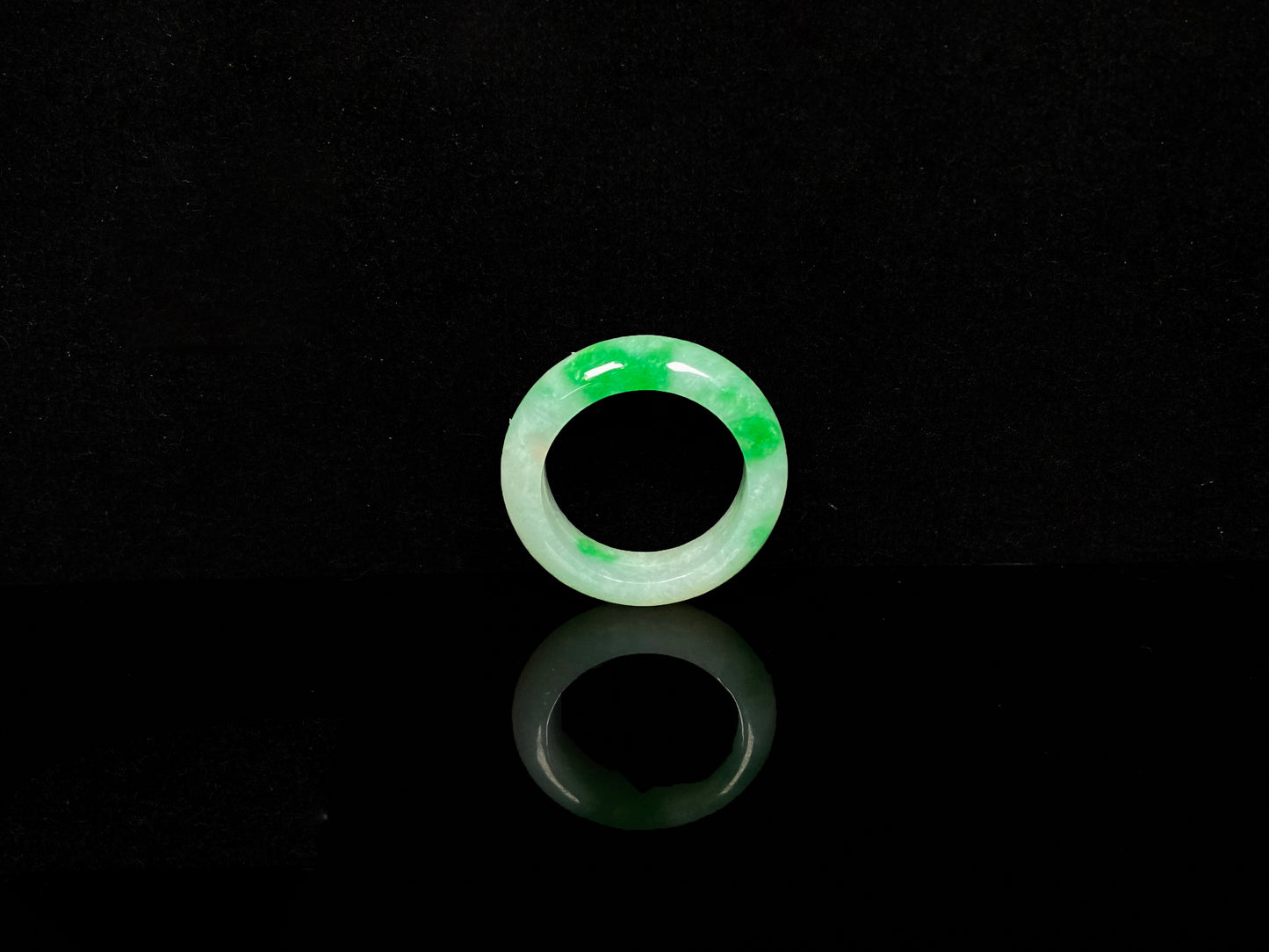 A lush green patch on white jadeite ring.
