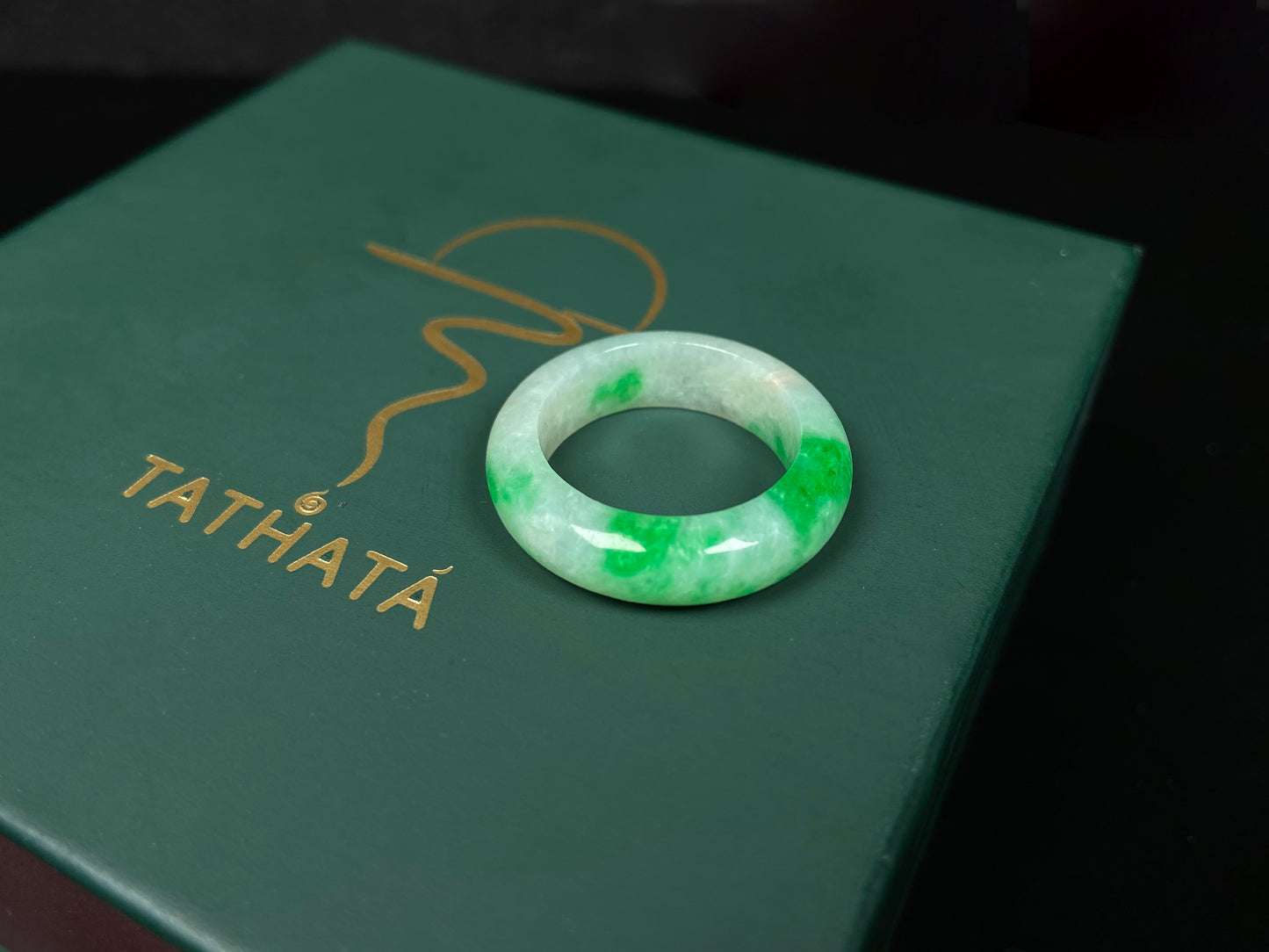 A lush green patch on white jadeite ring.