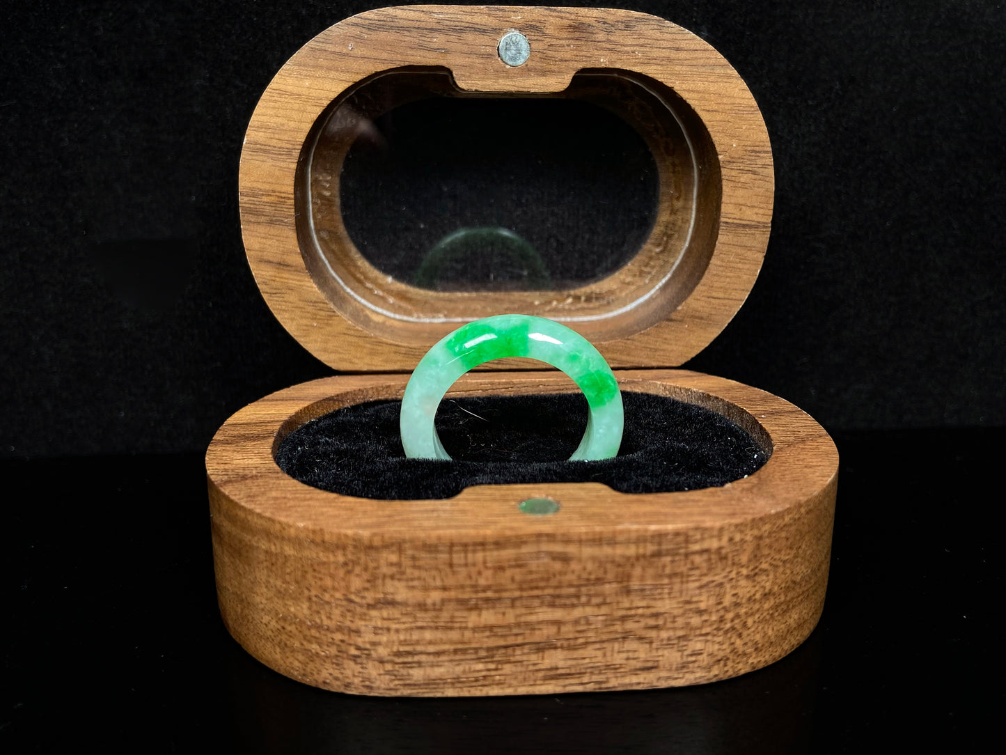 A lush green patch on white jadeite ring.