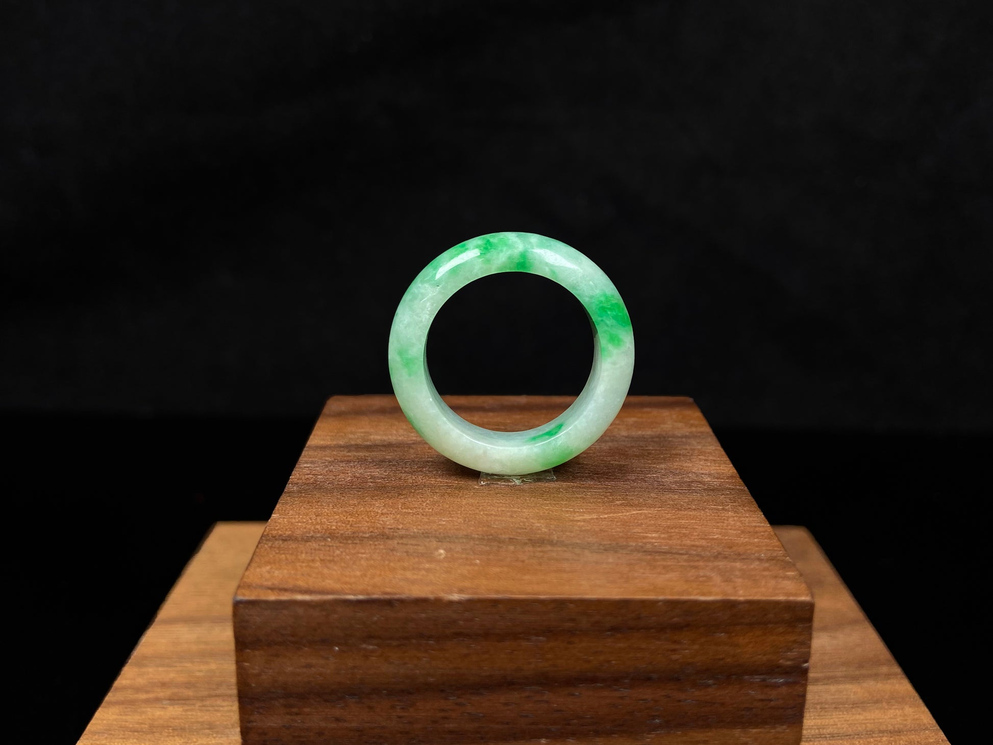 A lush green patch on white jadeite ring.