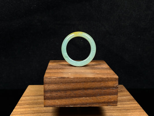 A icy yellow green smooth jadeite ring.