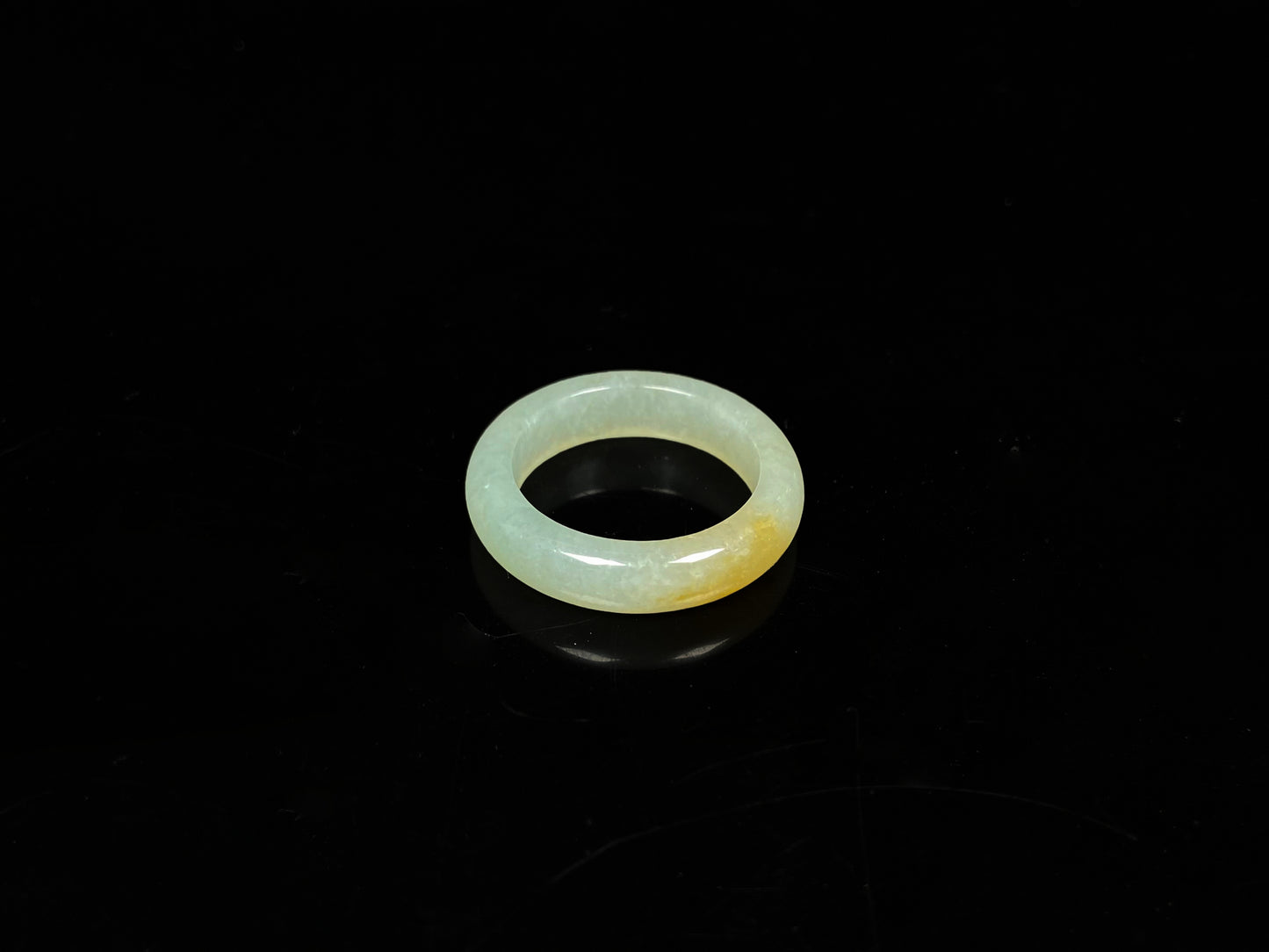 A icy yellow green smooth jadeite ring.