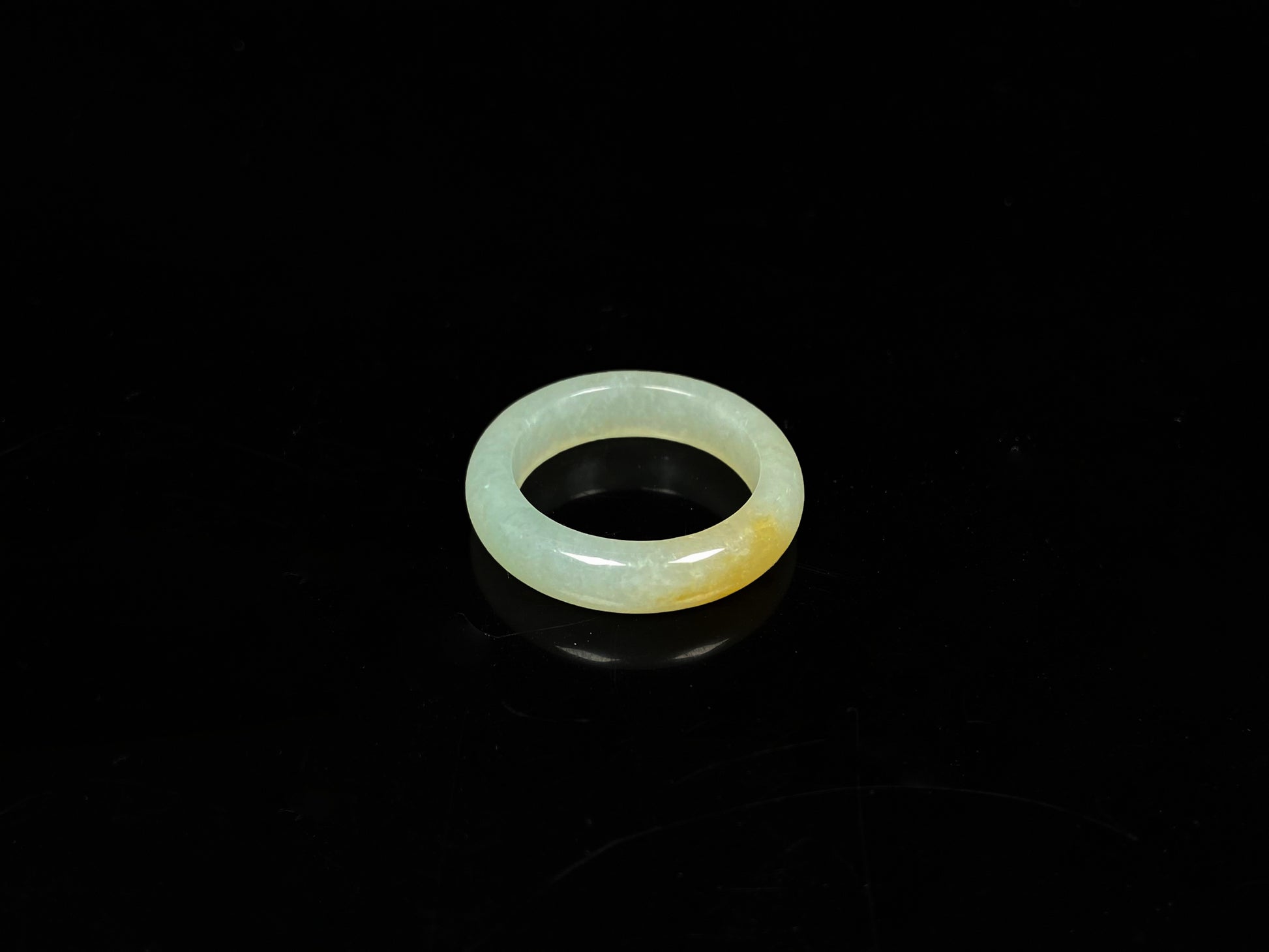 A icy yellow green smooth jadeite ring.