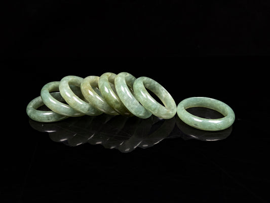 A group of pale mossy green jadeite ring.