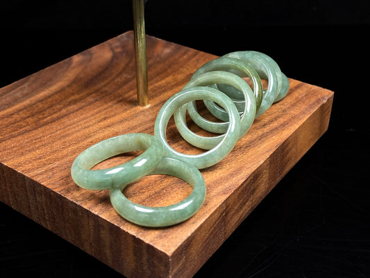 A group of pale mossy green jadeite ring.
