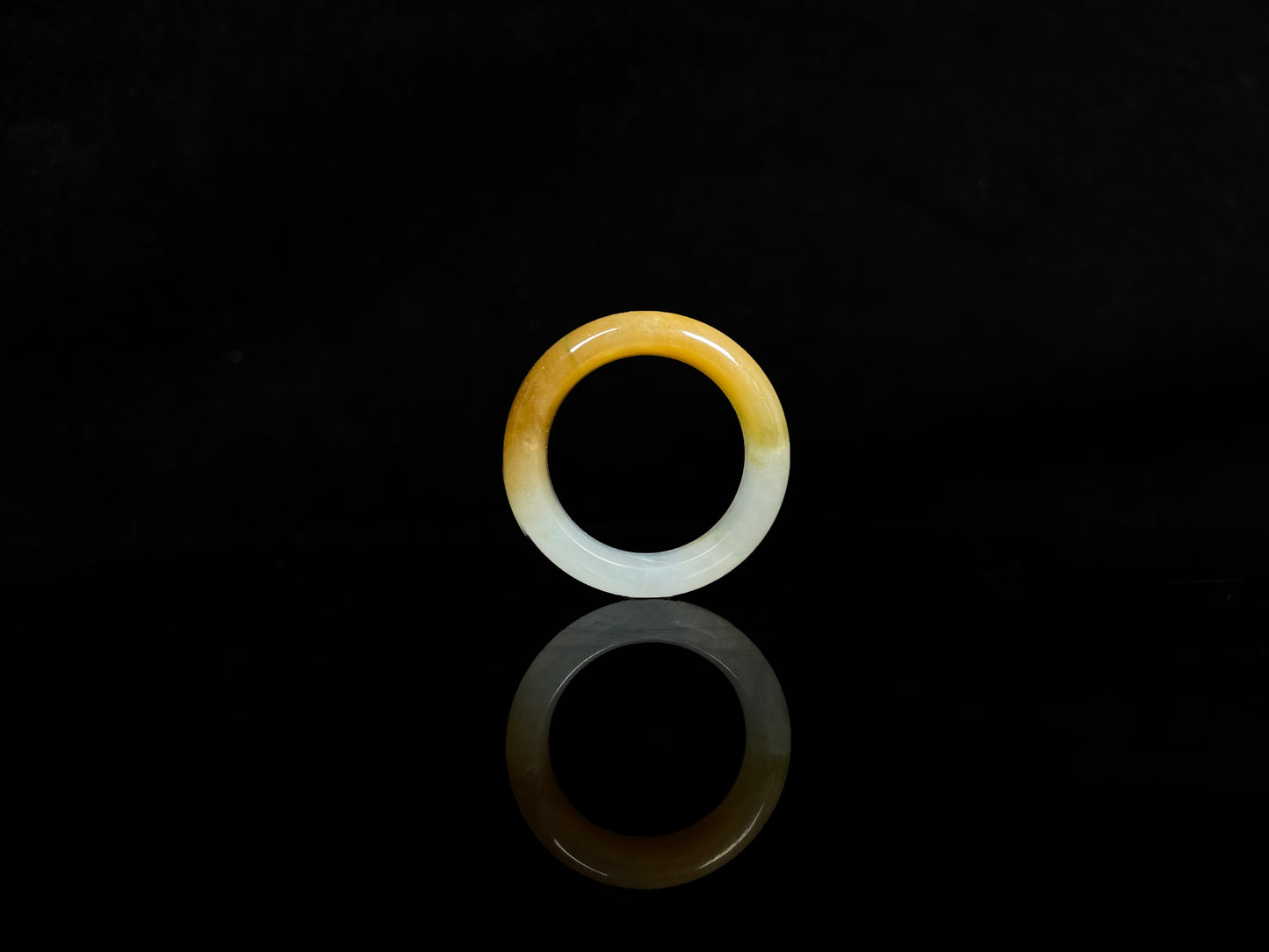 A gradient golden to milky jadeite ring.