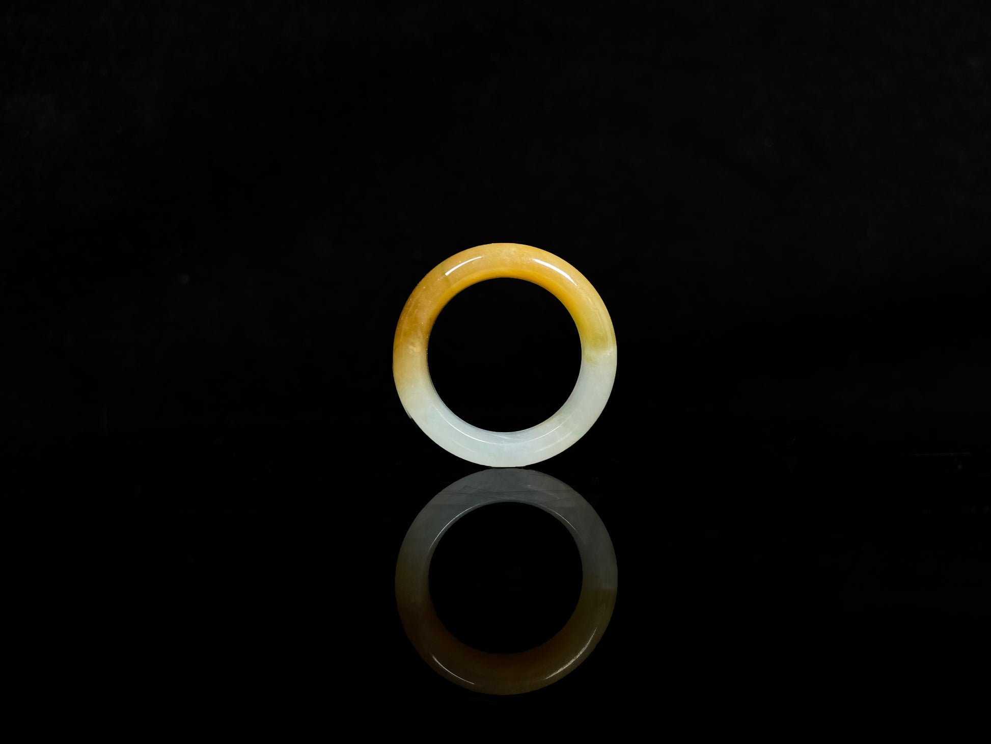 A gradient golden to milky jadeite ring.