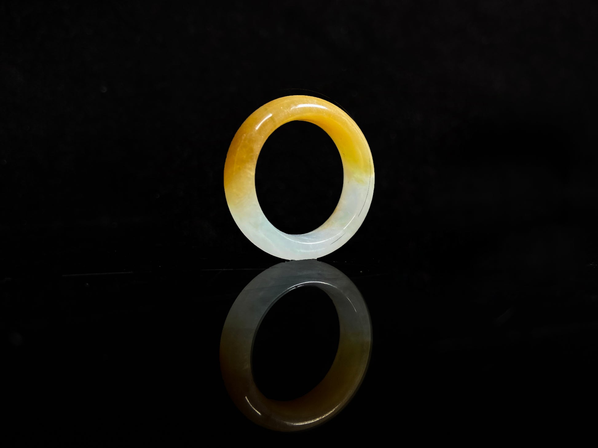 A gradient golden to milky jadeite ring.