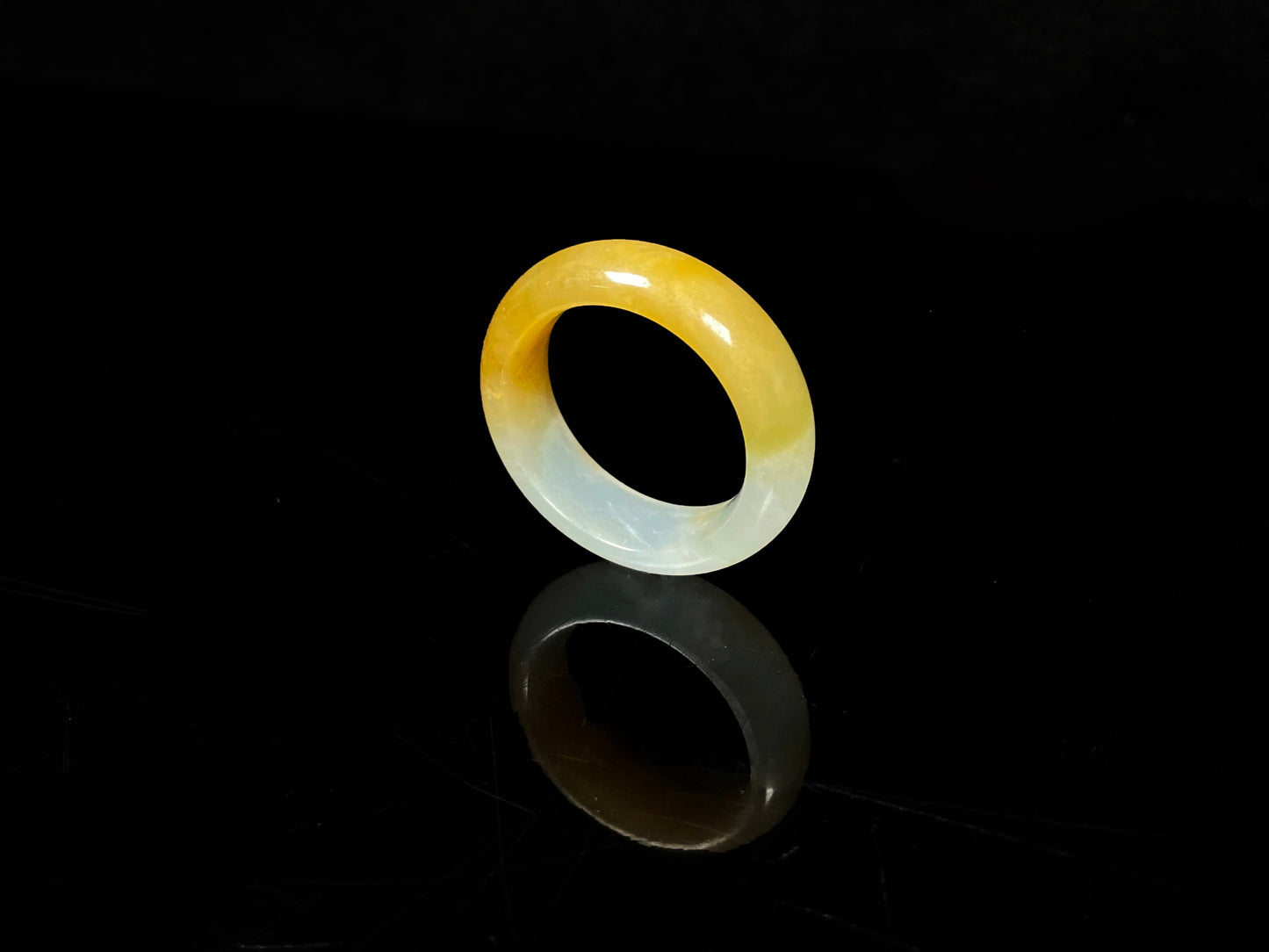 A gradient golden to milky jadeite ring.