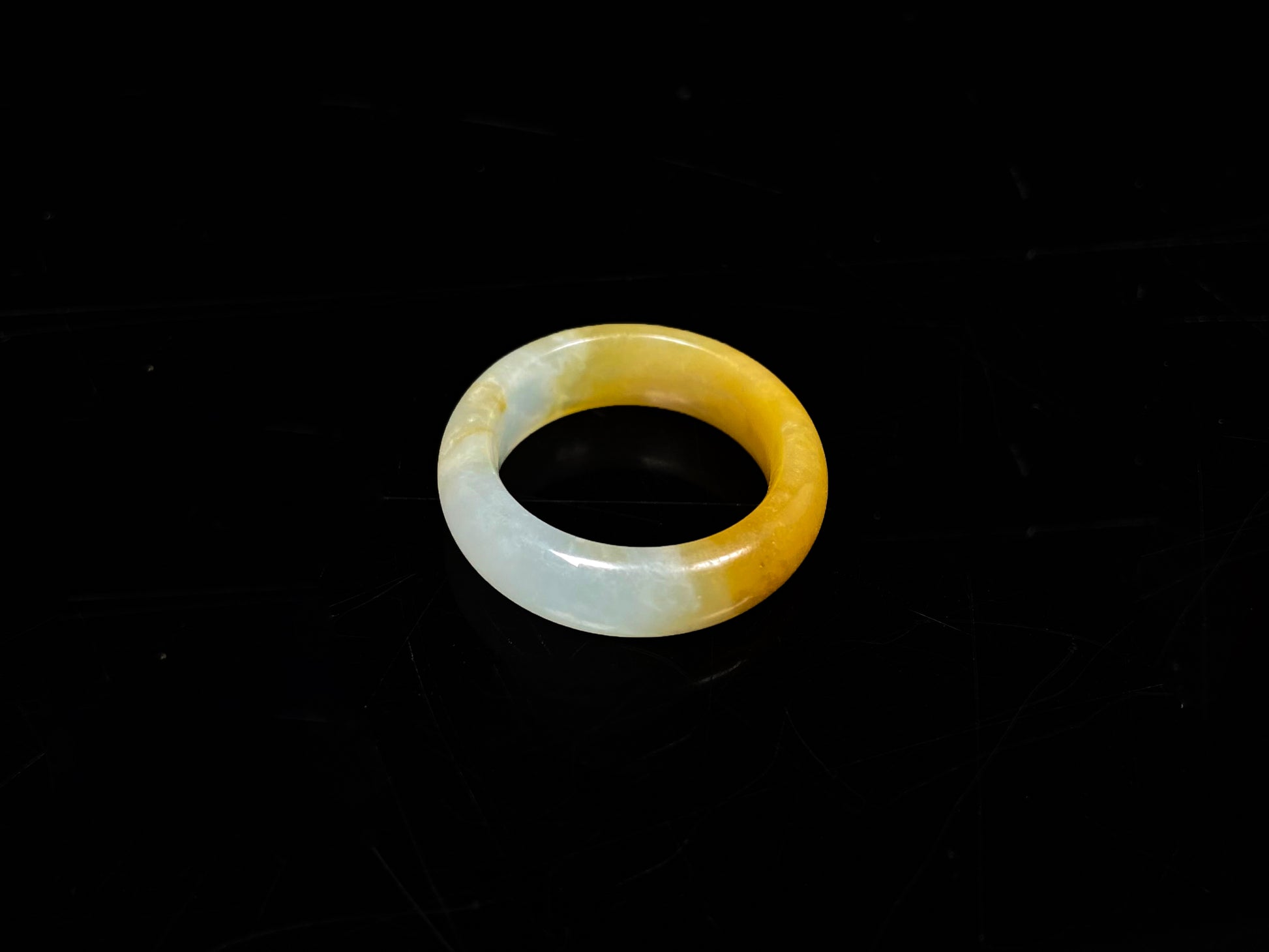 A gradient golden to milky jadeite ring.