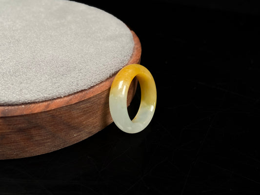 A gradient golden to milky jadeite ring.