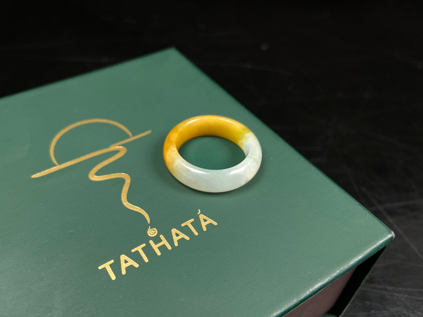 A gradient golden to milky jadeite ring.