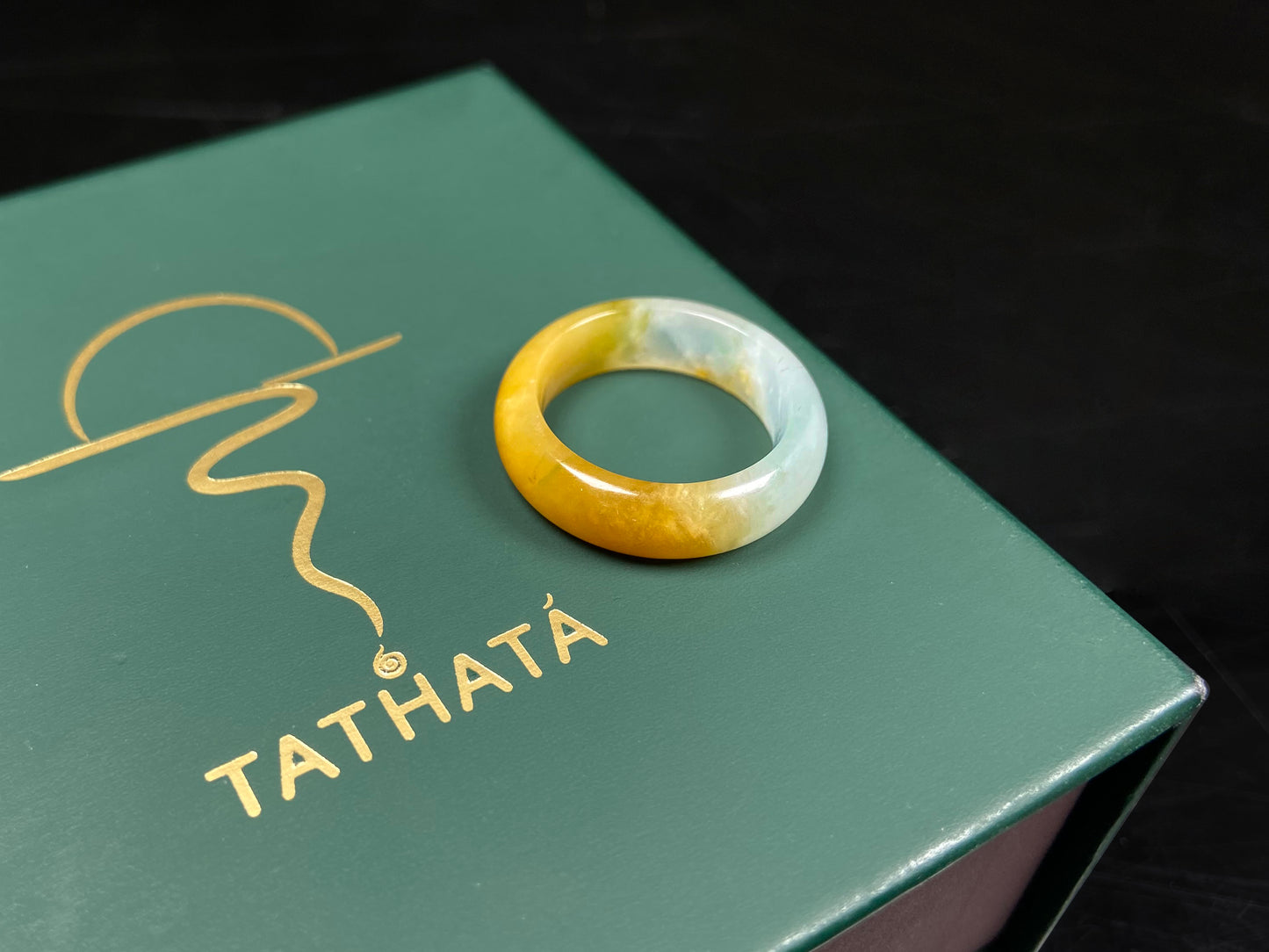 A gradient golden to milky jadeite ring.