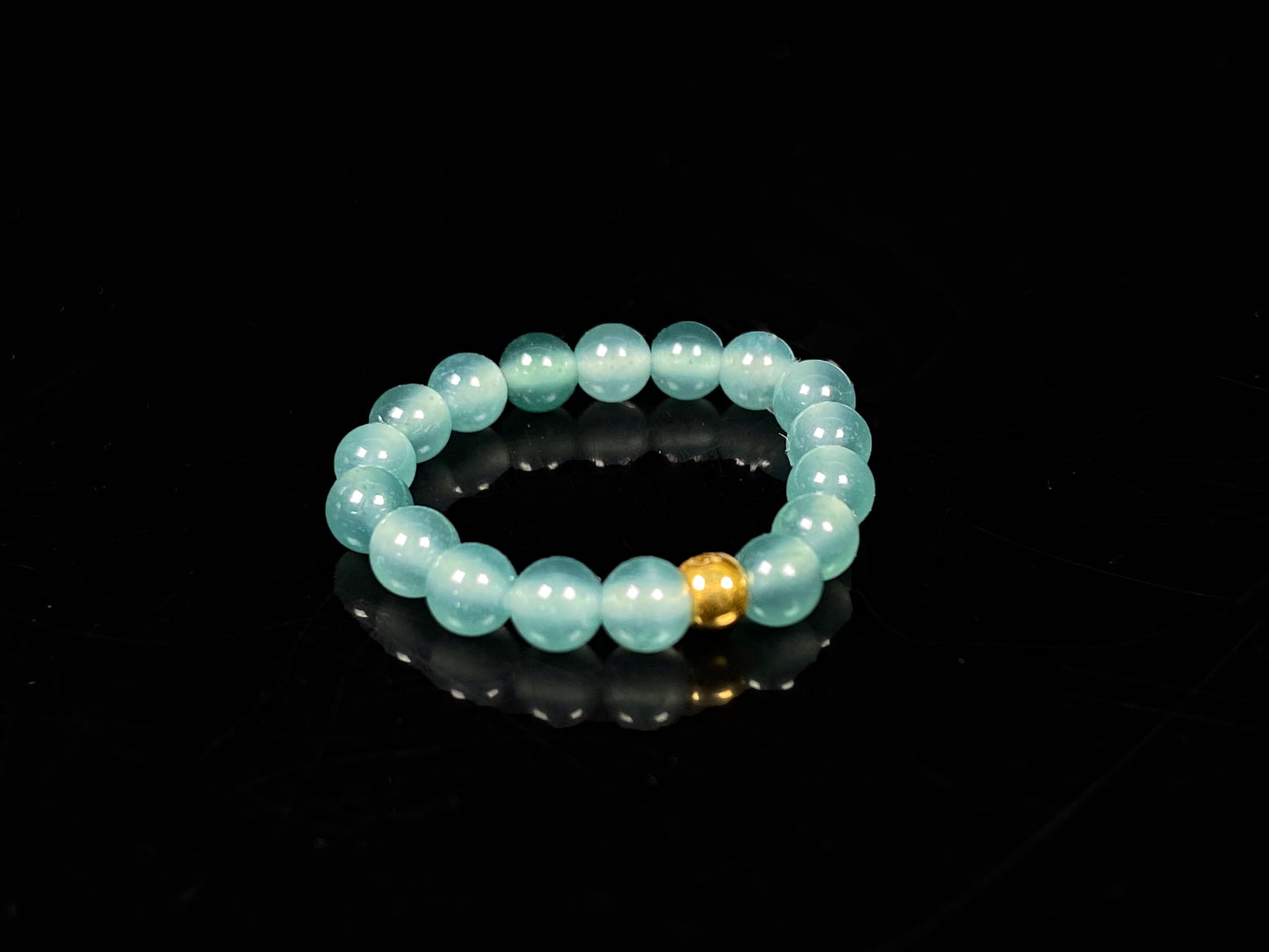 A gold center glacier blue jadeite ring.