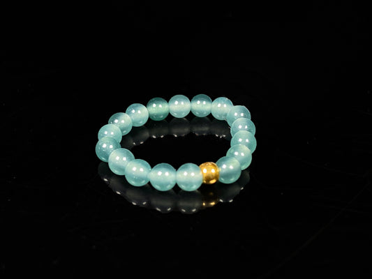 A gold center glacier blue jadeite ring.