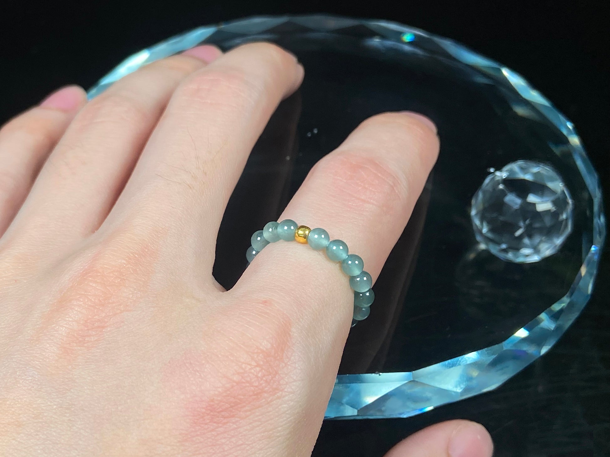 A gold center glacier blue jadeite ring.