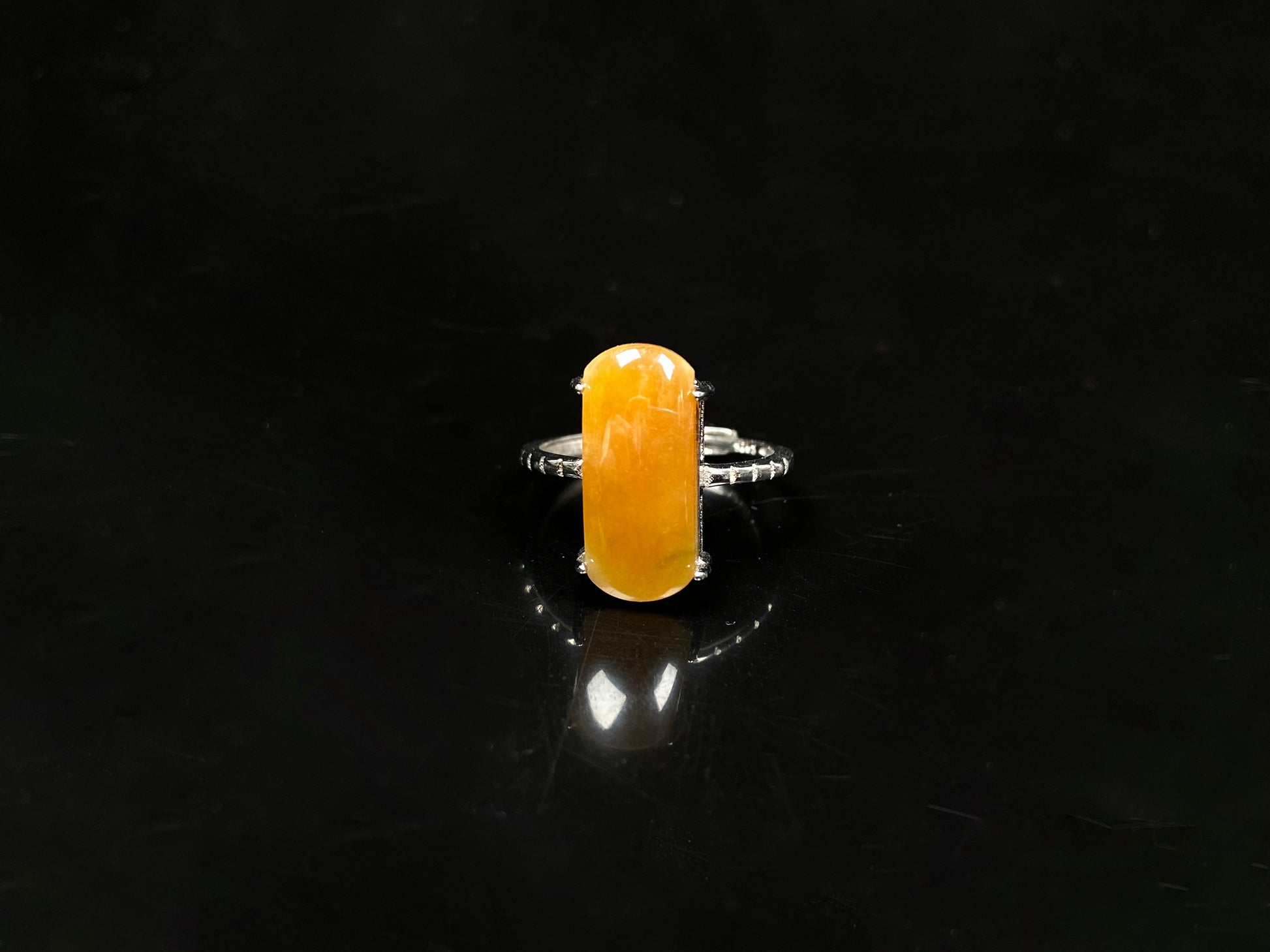 A butterscotch glow saddle jadeite ring.