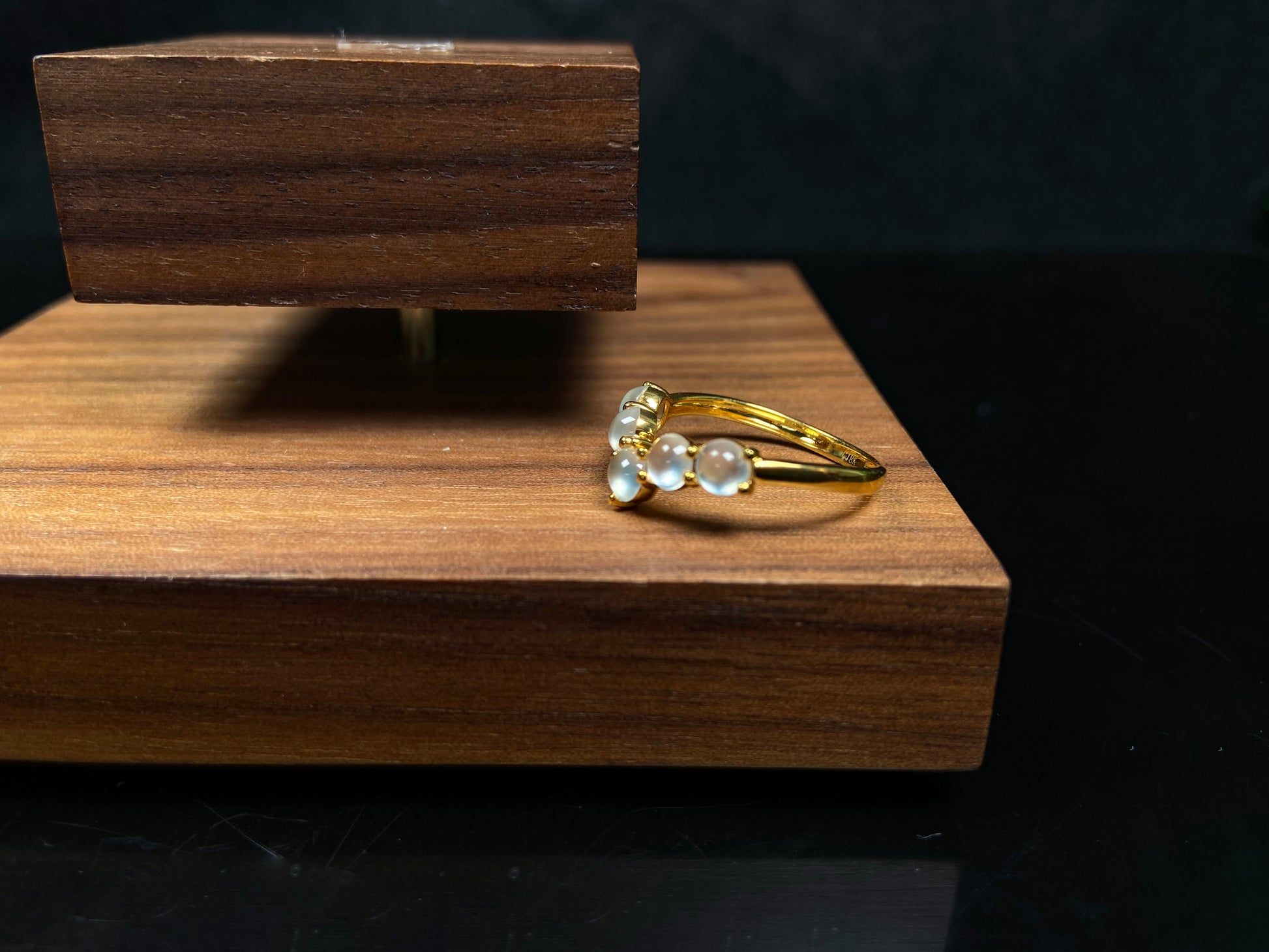A clear bead cluster crown on gold jadeite ring.
