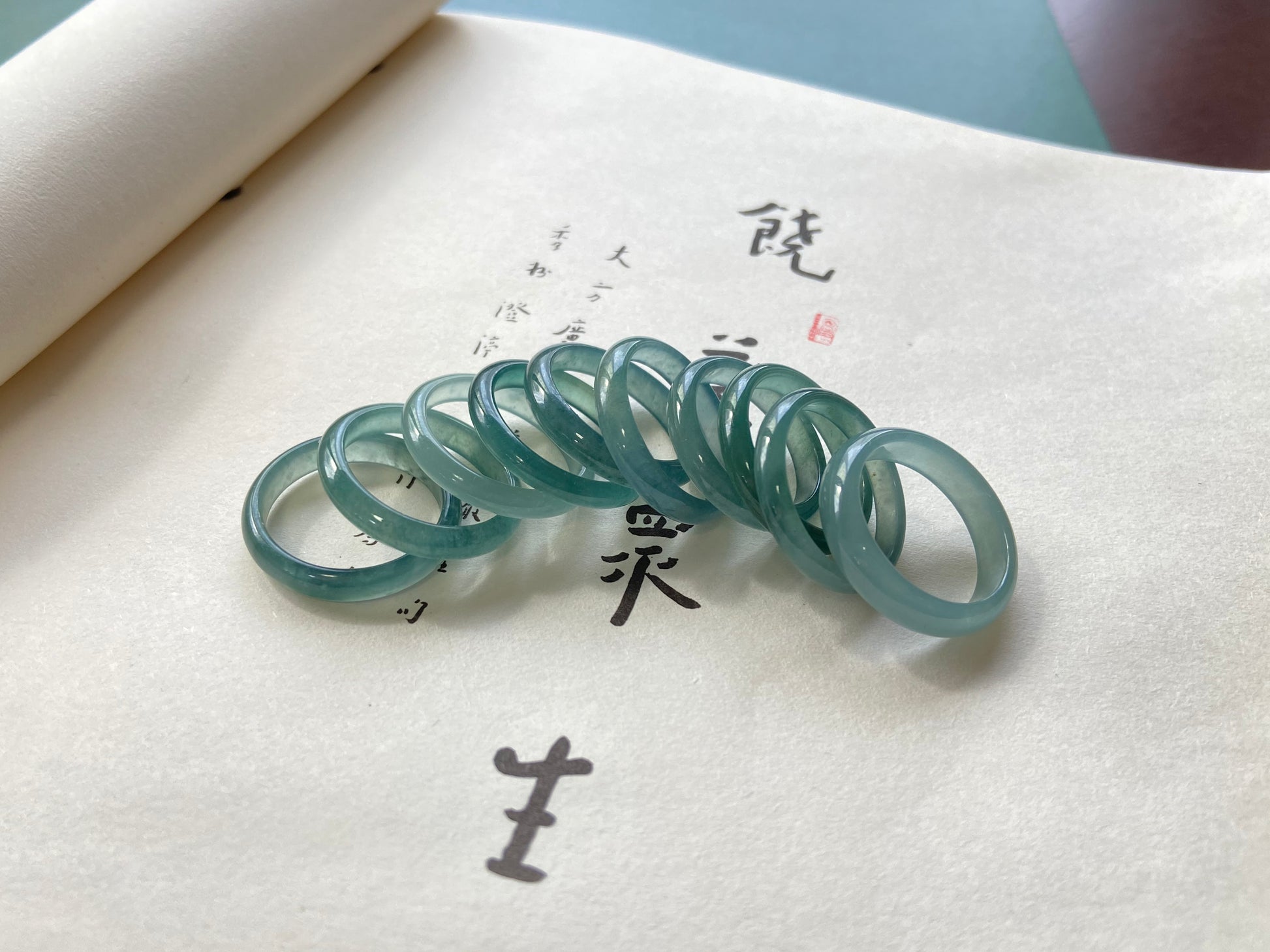 A glacial teal dew calm jadeite ring.