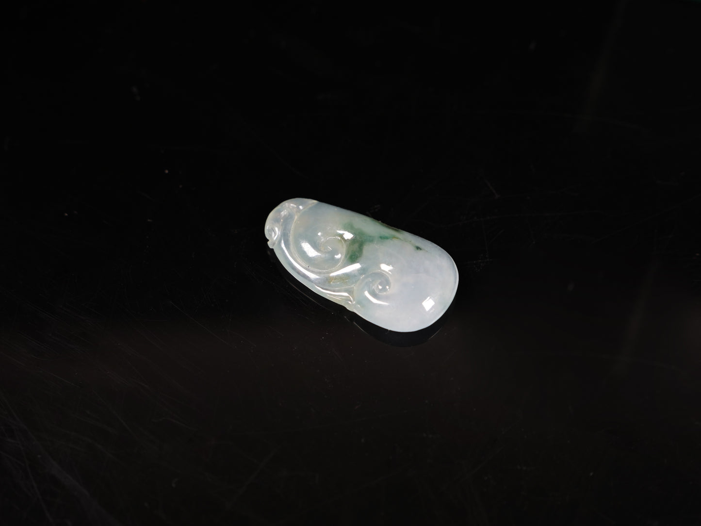 A icy translucent moss infused Ruyi loose jadeite.