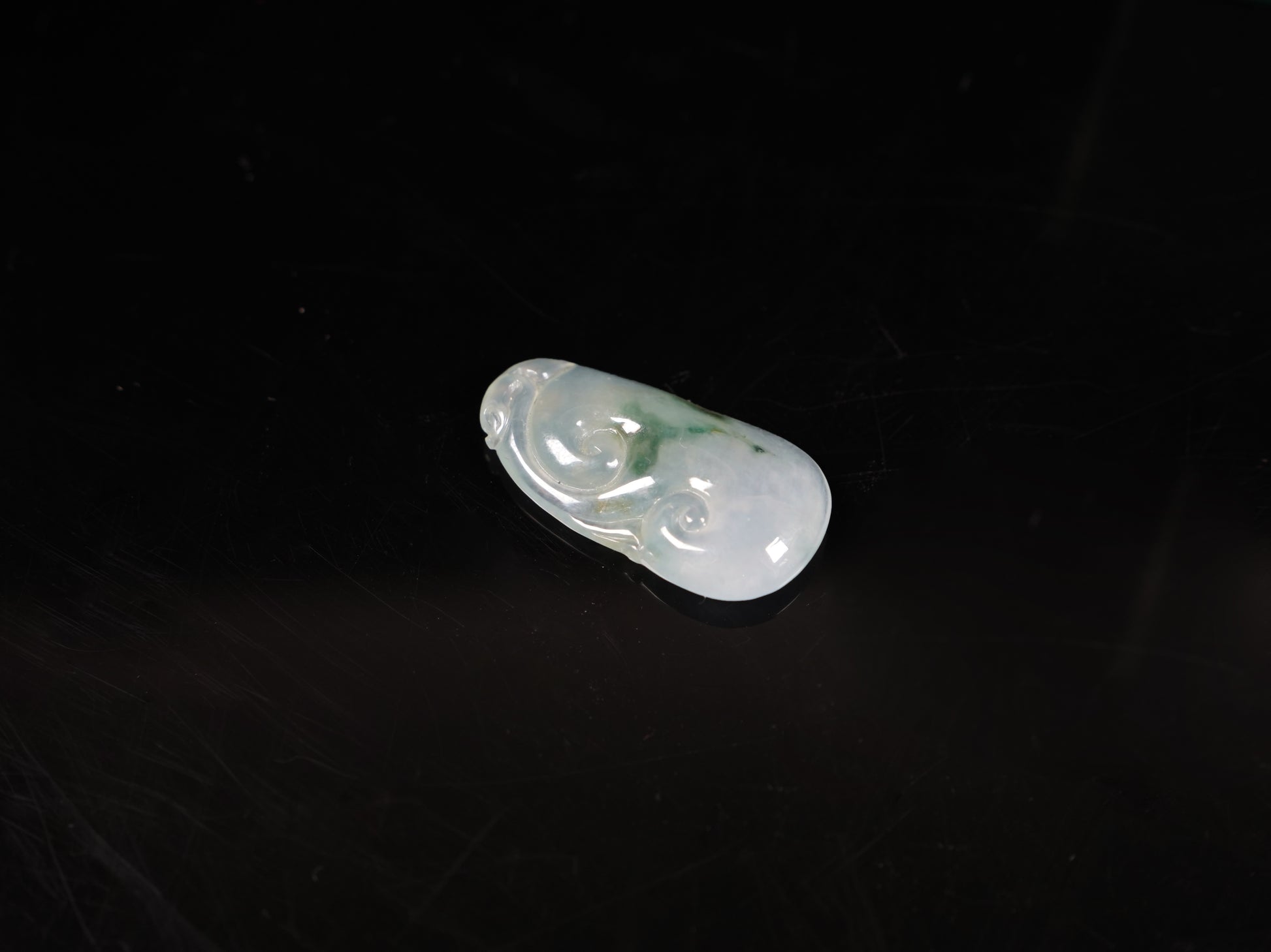 A icy translucent moss infused Ruyi loose jadeite.