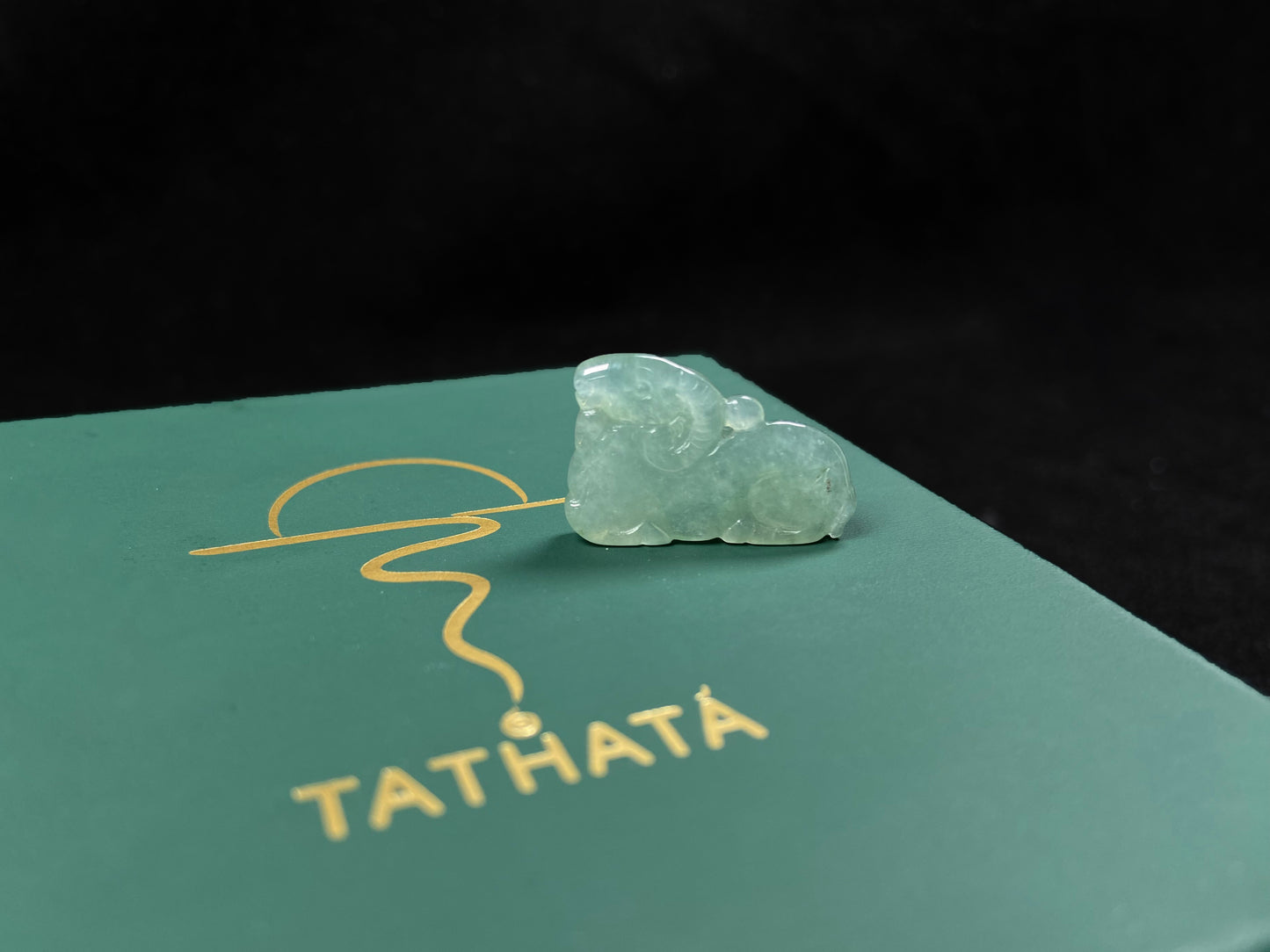 A lustrous pale green sheep loose jadeite.